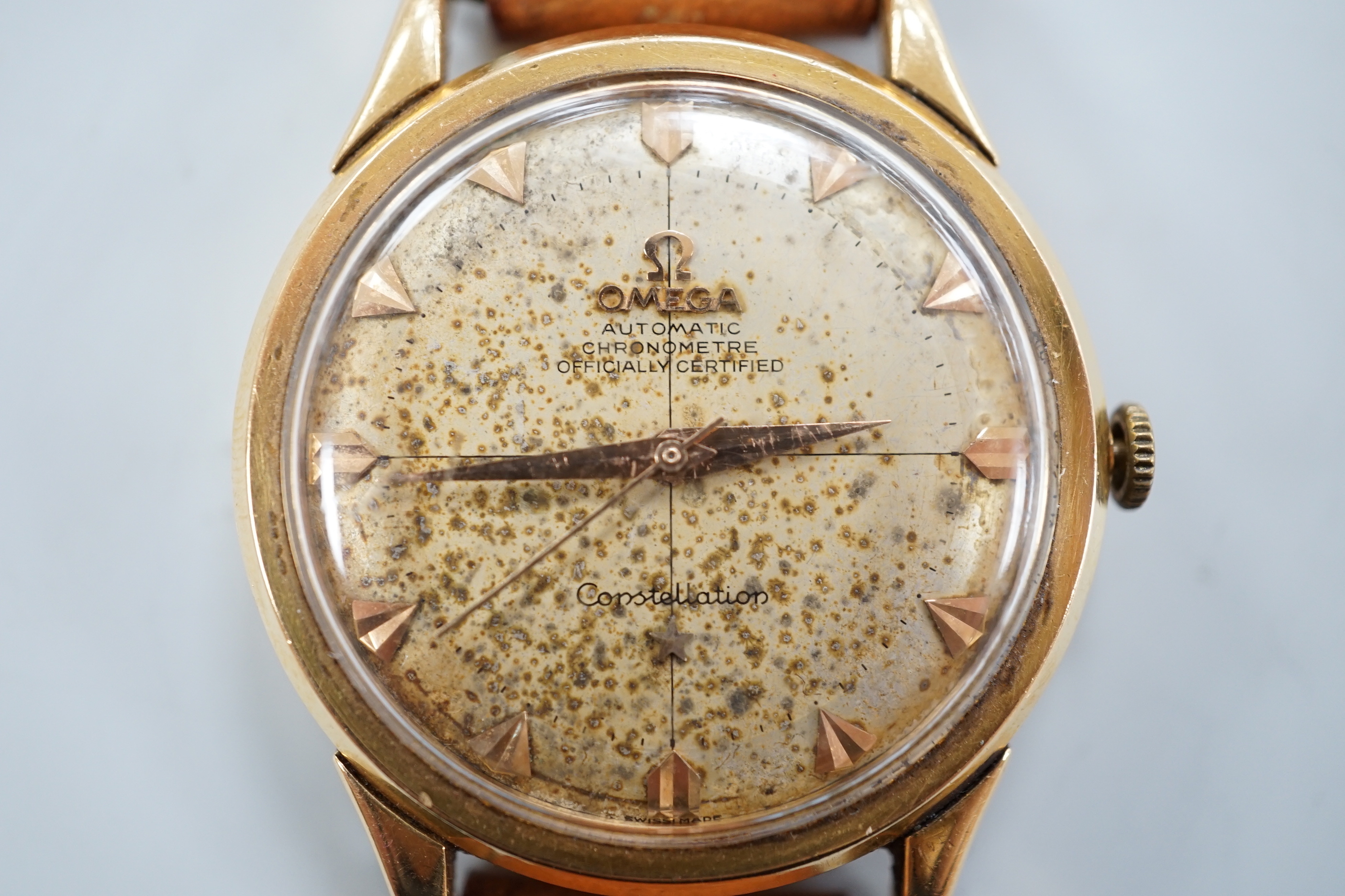 A gentleman's 1950's yellow metal (French 18ct poincon mark) Omega Constellation automatic wrist watch, on associated strap, case diameter 35mm, dial a.f.